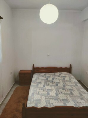 Cozy retreat with a single bed, nightstand, and storage unit.