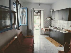 Cozy kitchen with a modern design, featuring a sink, stove, and balcony access.