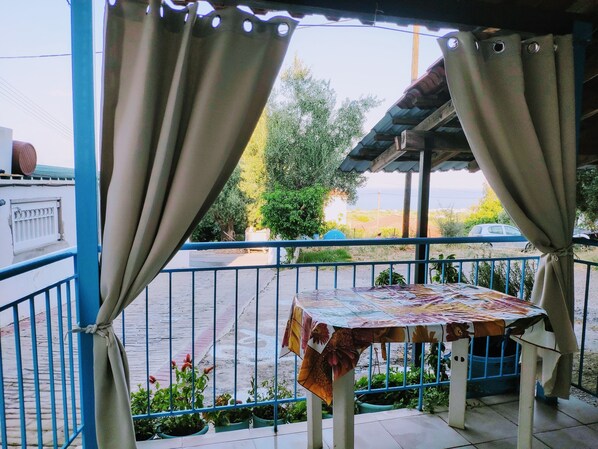 Relax in this charming outdoor seating area with a view of the street and surrounding greenery.