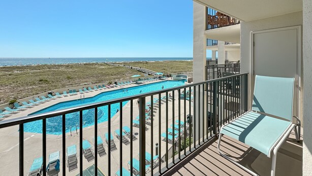 A balcony with a view of a pool and beach. - Phoenix VII 212 | Beachfront | Heated Indoor Pool | My Beach Getaways (Orange Beach)