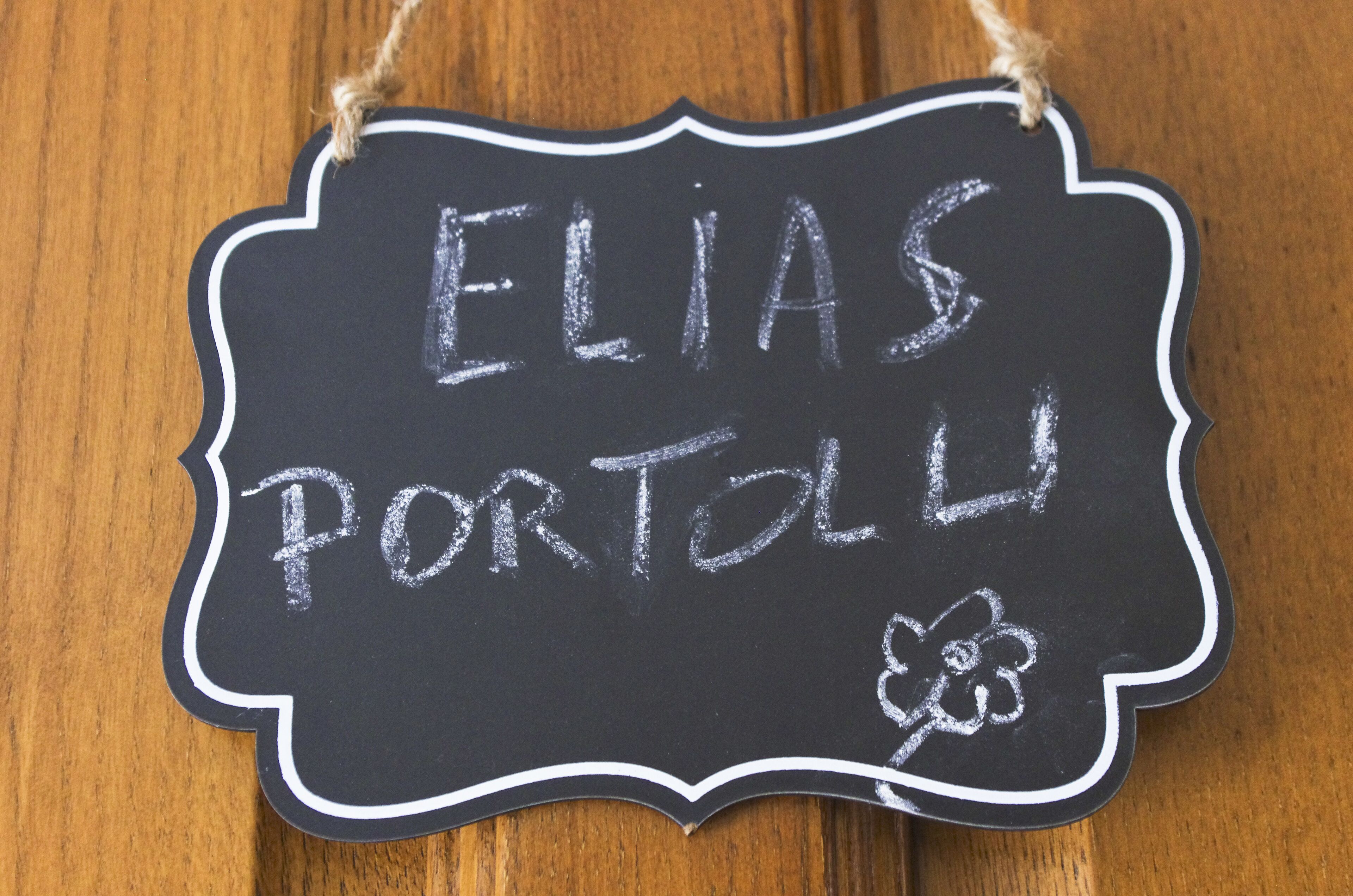 A chalkboard sign with the text "ELIAS PORTAL" and a small flower drawing.