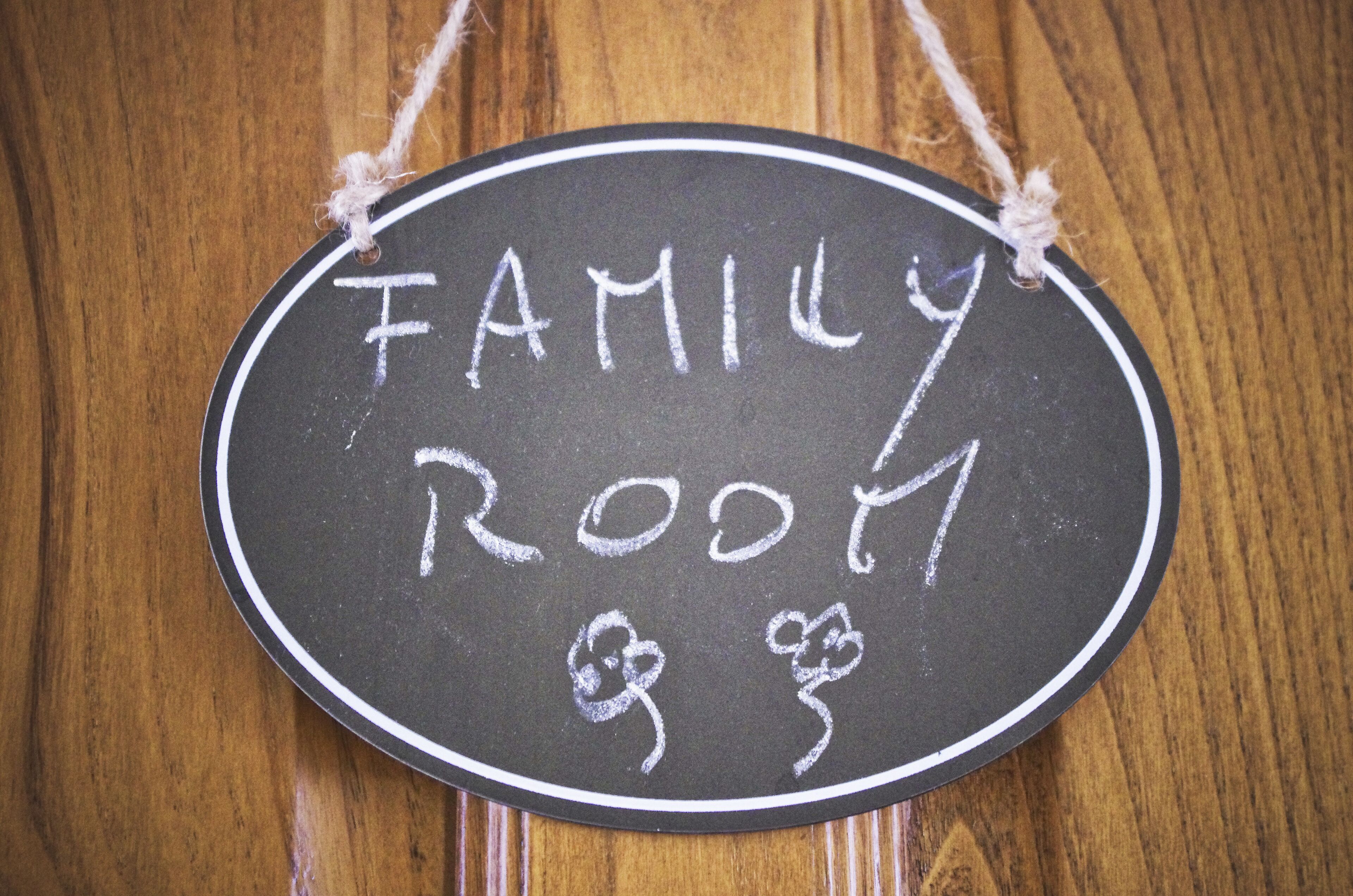 A chalkboard sign with "FAMILY ROOM" written on it, surrounded by a simple rope border.