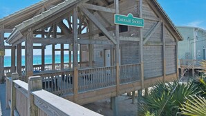 A wooden beach house with a sign reading "Emerald Shores." - Renovated Pet Friendly Home-Private Beach Access (Destin)