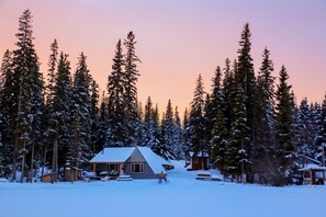 A cabin surrounded by snow-covered trees. - Gorgeous Lakefront cabin, pet friendly! (Sheridan Lake)
