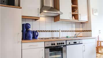 Fridge, stovetop, dishwasher, coffee/tea maker