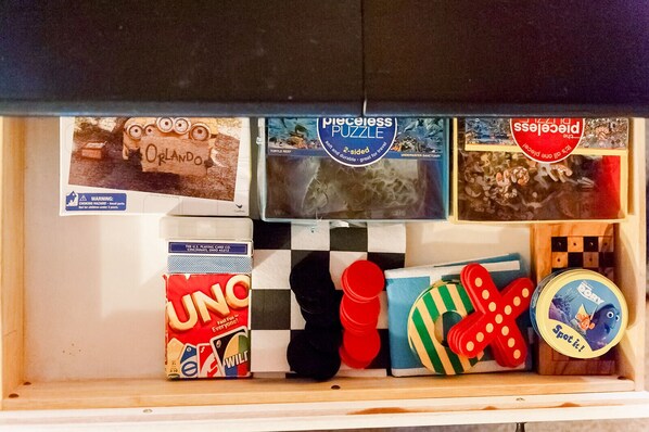 A drawer containing a puzzle box, a UNO card game, a checkered board, and various toys. - 🌲Log cabin in Payson. Fast Wifi. Large Patio. Long term discounts. (Payson)
