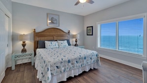 A bedroom with a wooden bed, a ceiling fan, a window with blinds, and a nightstand with a lamp. - ESCAPES1700sqft/updated/beachfront/Sleeps8 FREE BEACH SERVICE for 2-Mar-Oct (Orange Beach)