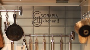 A kitchen with hanging utensils and a stove. - SORAPIA Villa Mt.Fuji Front (Fujikawaguchiko)