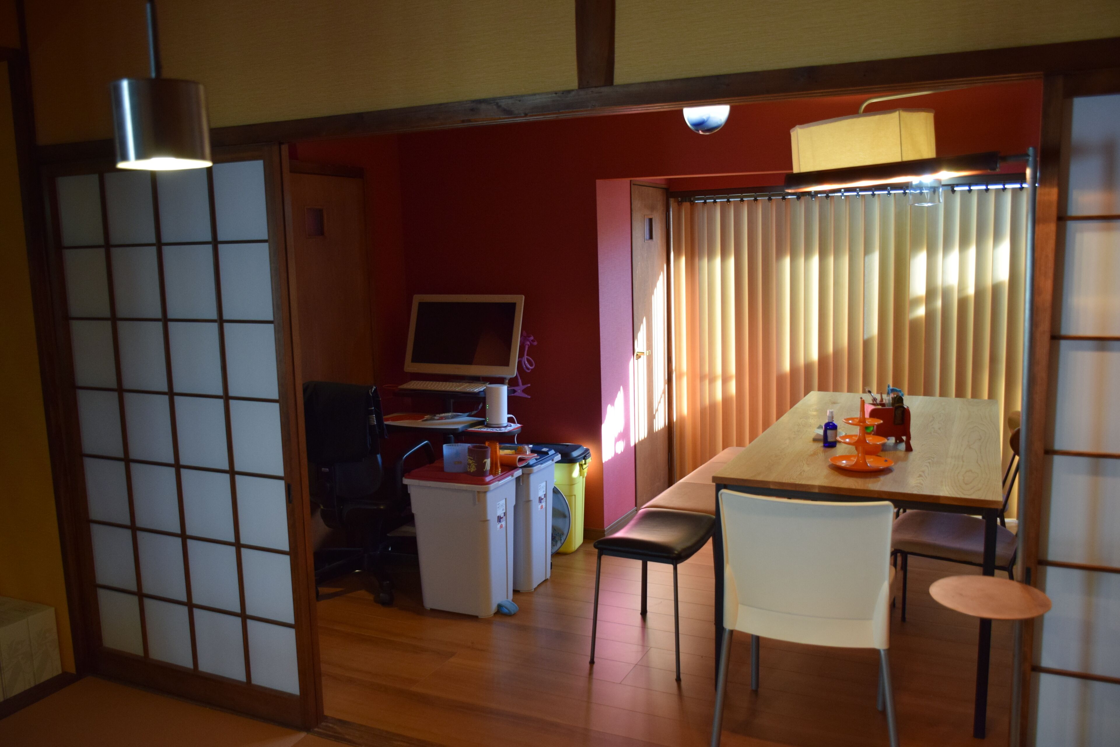 A traditional Japanese-style room with tatami flooring, a low table, and a sliding door.