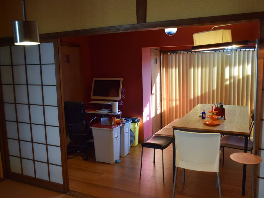 A traditional Japanese-style room with tatami flooring, a low table, and a sliding door.