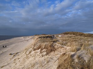 A sandy beach with dunes and a small building. - Lister Dünennest, Deutschland (List)