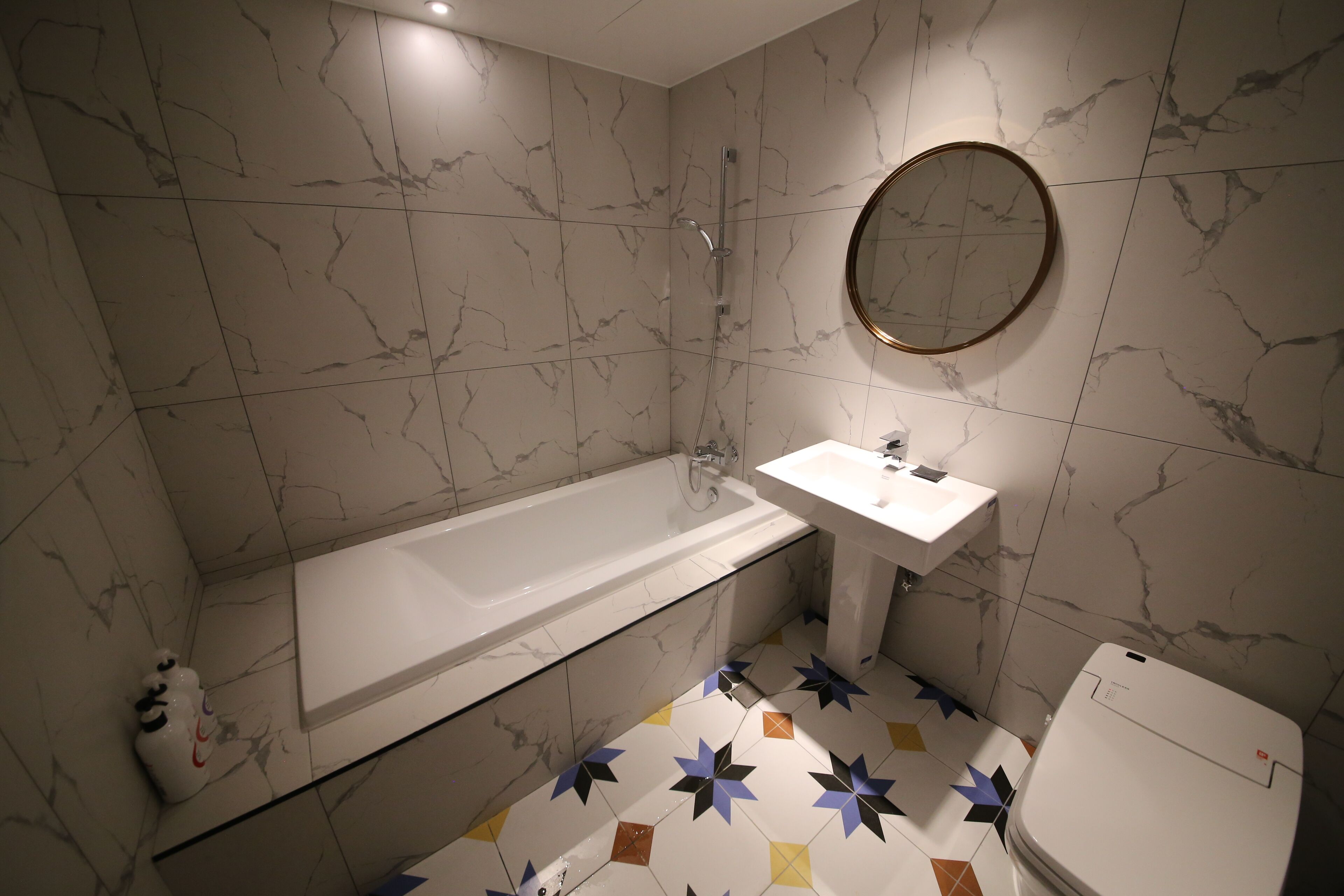 deluxe room | bathroom | hair dryer, slippers, towels, soap