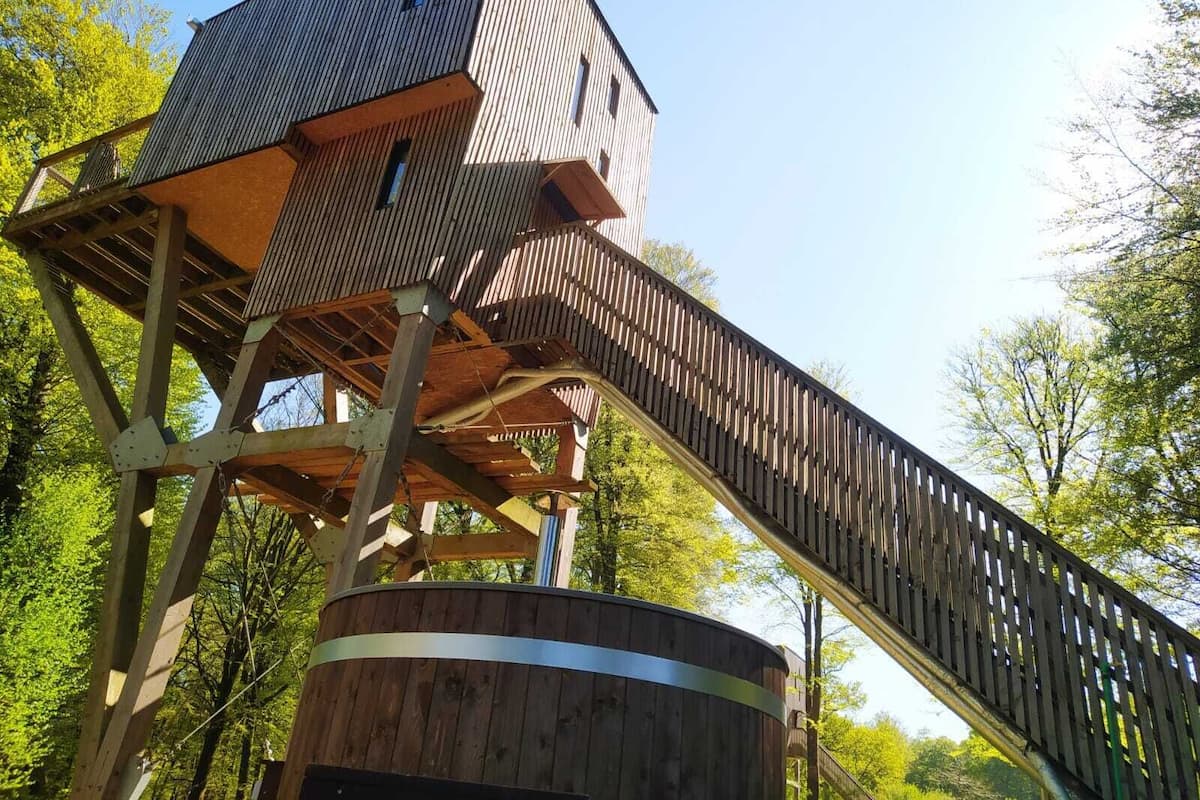 A wooden observation tower with a spiral staircase.