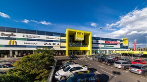 A shopping center with stores like Zara and Interspar.