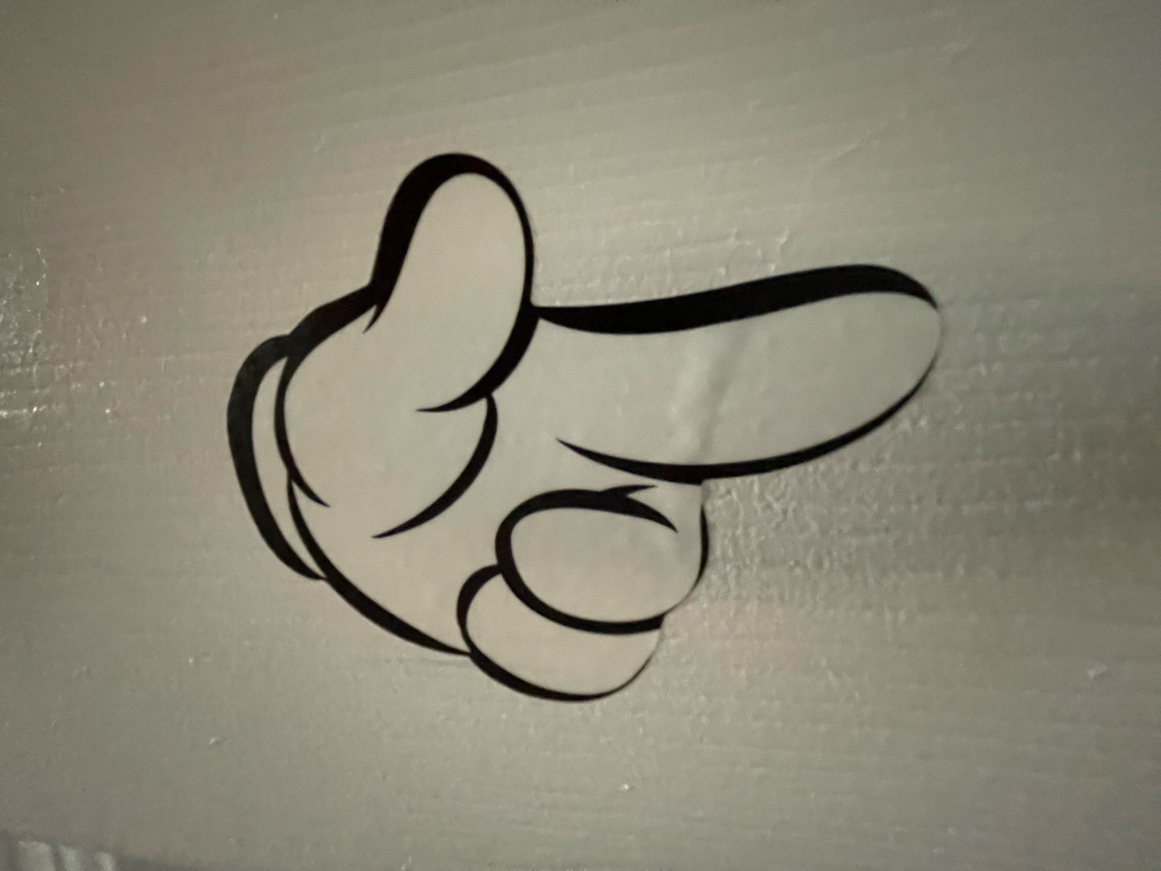 A hand giving a thumbs-up gesture.