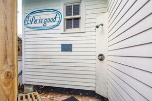 A house with a sign that says "Life is good" and another sign that reads "Captain Jack can count on my booty."