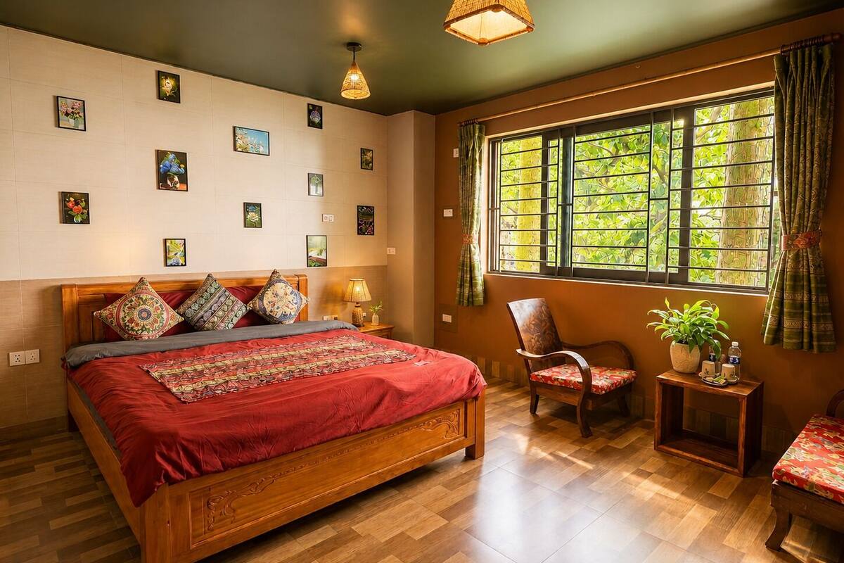 A bedroom with a wooden bed, a chair, a small table with a plant, and a window with curtains.