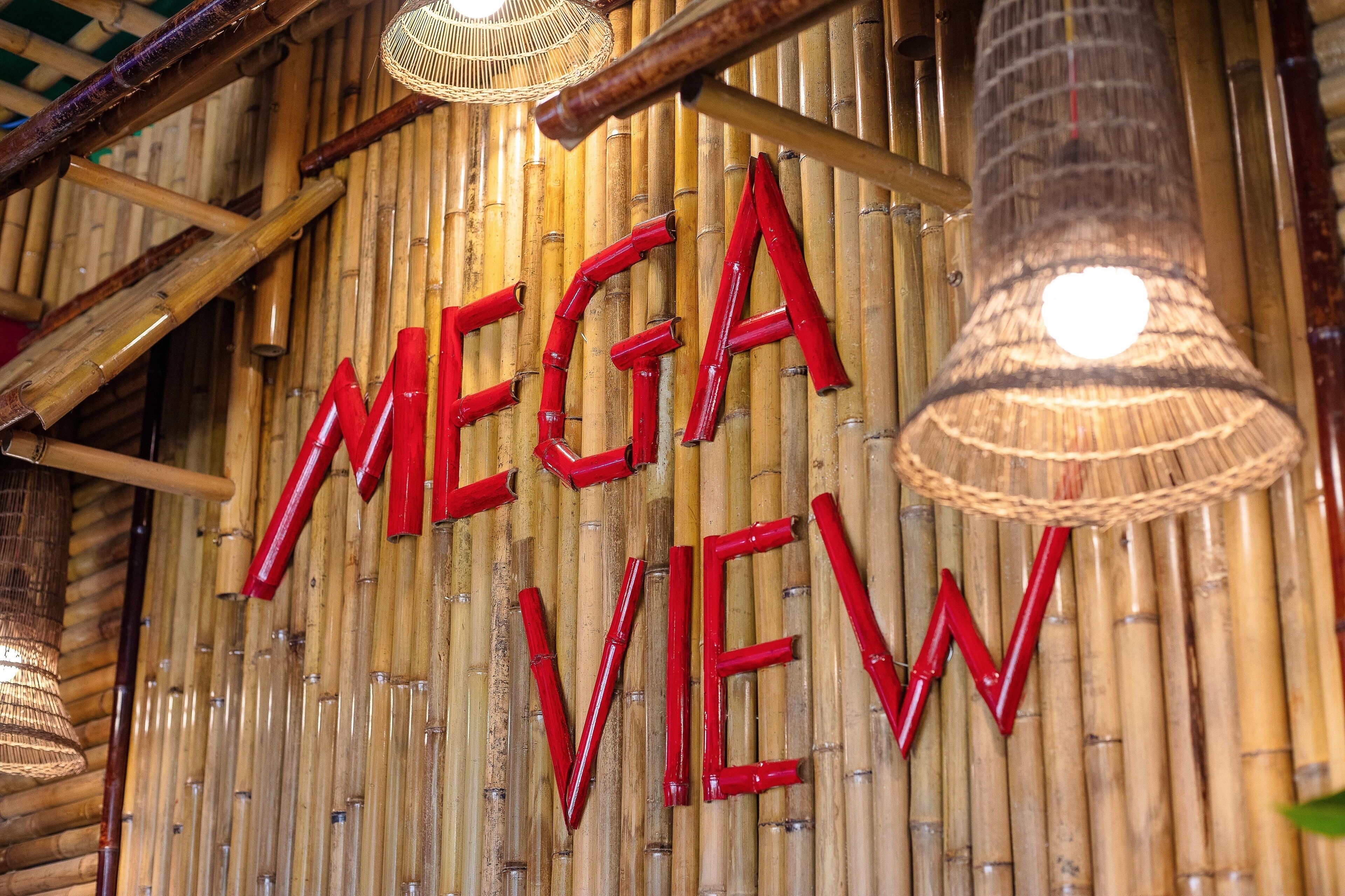 A bamboo wall with the words "MEGA VIEW" in red letters.