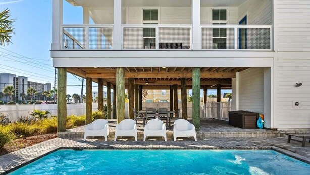 A modern two-story house with a covered outdoor seating area and a swimming pool. - Red Fish Blue Fish🐟Private Pool Home👙Dogs OK🐶 (Okaloosa Island)