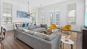A modern living room with a grey sectional sofa, a yellow armchair, and a coffee table. - Red Fish Blue Fish🐟Private Pool Home👙Dogs OK🐶 (Okaloosa Island)