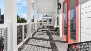 A covered porch with a bench and a door, overlooking a residential area. - 1 Fish 2 Fish🐟Private Pool Home👙Dogs OK🐶 (Okaloosa Island)