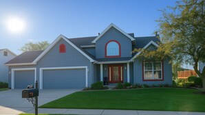 A two-story house with a garage, a front porch, and a well-maintained lawn. - Fairway Haven at The Falls – Golf, Shops, Dining! 10-12 Mins. Equestrian Center (O'Fallon)