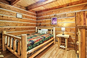 Cozy bedroom with a single bed and a bedside table featuring a lamp.