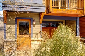 A wooden cabin with a front door, a small porch, and a window. - KBM Resorts | Private Home | Split AC in living room | Walk to Town and to Ski Access, Hot Tub and Fire Pit! PNF-860 (Park City)