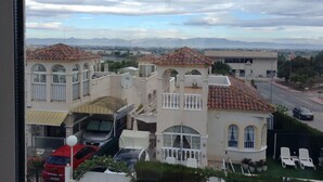 A residential area with multiple houses, each featuring a tiled roof and arched windows. - Fully licensed 2 bedroom 2 bathroom detached villa with private pool .  (Benimar rojales)