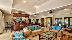 A spacious living area with a kitchen, dining area, and a large open space with a view. - Villa Tranquila (Tamarindo)