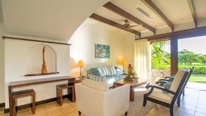 A spacious living room with a sofa, armchairs, a coffee table, and a dining area. - Villa Mansita (Tamarindo)