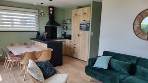 Eine moderne Küche mit einer zentralen Kochinsel, Holzschränken und einem eingebauten Ofen.