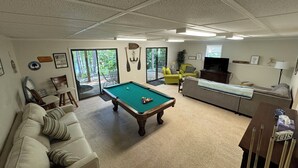 A living room with a pool table, a sofa, a television, and a dining area. - LAKEFRONT HARTWELL! Good dogs welcome! Covered dock, fire pit, kayaks! (Westminster)