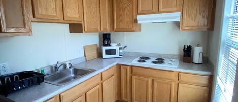 Fridge, stovetop, coffee/tea maker, cookware/dishes/utensils