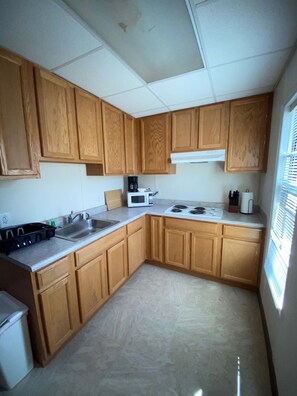 Fridge, stovetop, coffee/tea maker, cookware/dishes/utensils