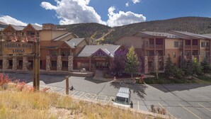 A lodge with a sign reading "Hidden River Lodge" and a parking lot in front.