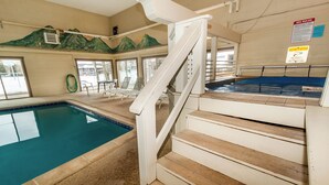 A swimming pool with a wooden staircase leading to a spa area. - Dillon Valley East by Summit County Mountain Retreats (Dillon)
