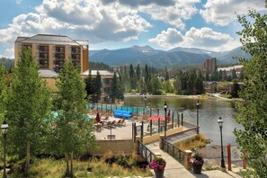 A hotel with a pool area, surrounded by mountains and a lake. - Water House #6204 by Summit County Mountain Retreats (Breckenridge)