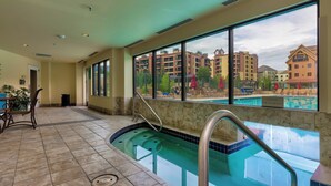 An indoor swimming pool with a view of surrounding buildings. - Water House #6204 by Summit County Mountain Retreats (Breckenridge)