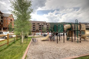 Kids can play on the slide and climbing structures in this outdoor playground.