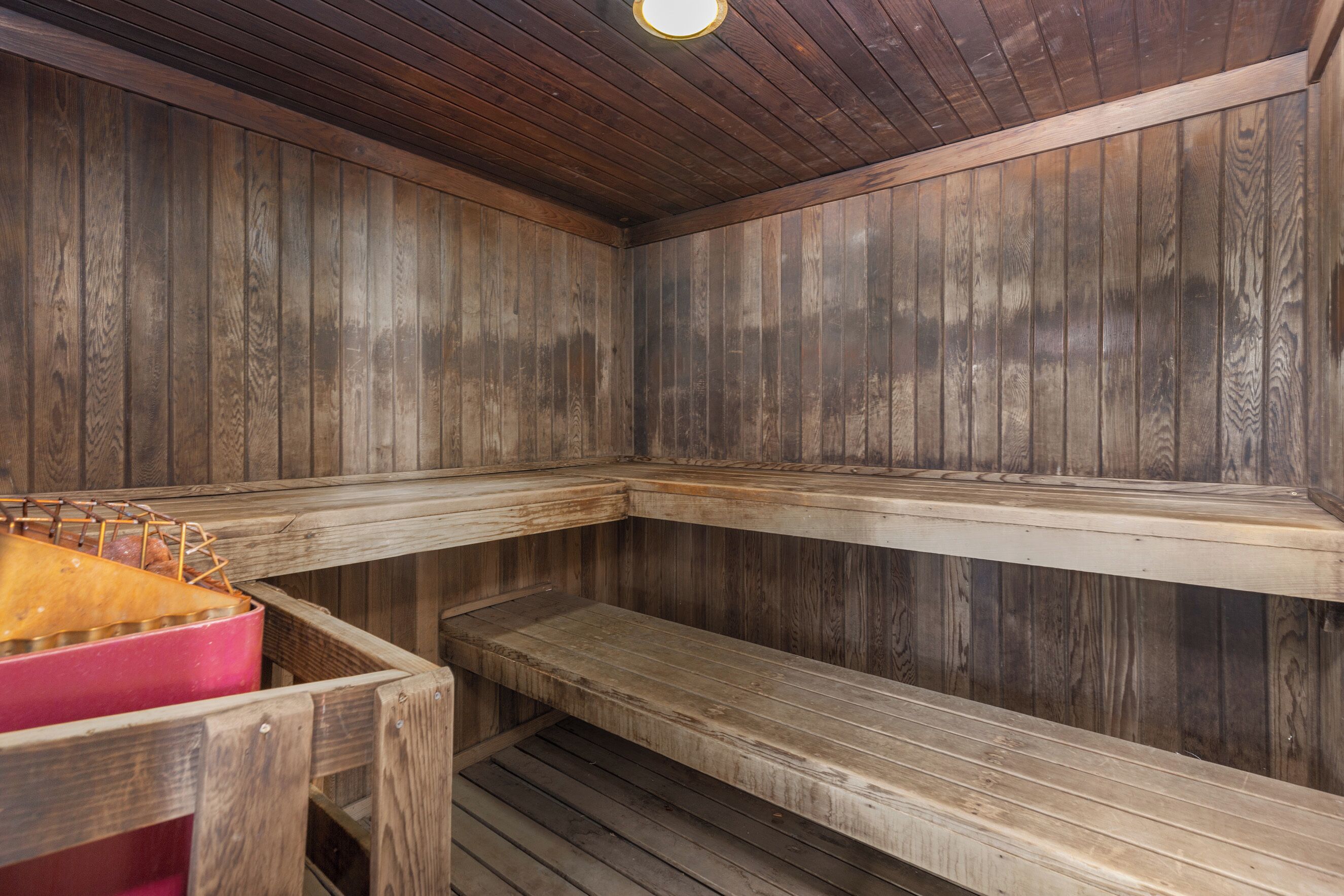 A sauna with wooden walls and benches.