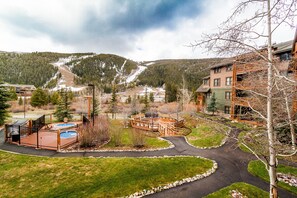 A resort with a pool, a wooden deck, and a mountain backdrop. - Tenderfoot Lodge by Summit County Mountain Retreats (Keystone)