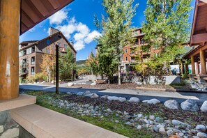 Stroll through a charming neighborhood with a mix of modern and traditional architecture, featuring multi-story buildings with balconies and a beautifully landscaped environment.