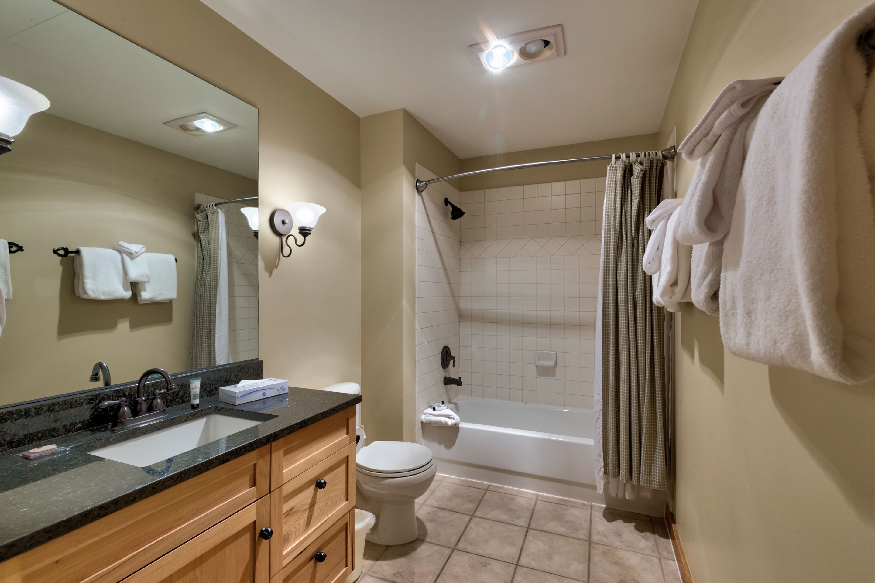 A bathroom with a sink, toilet, and bathtub.