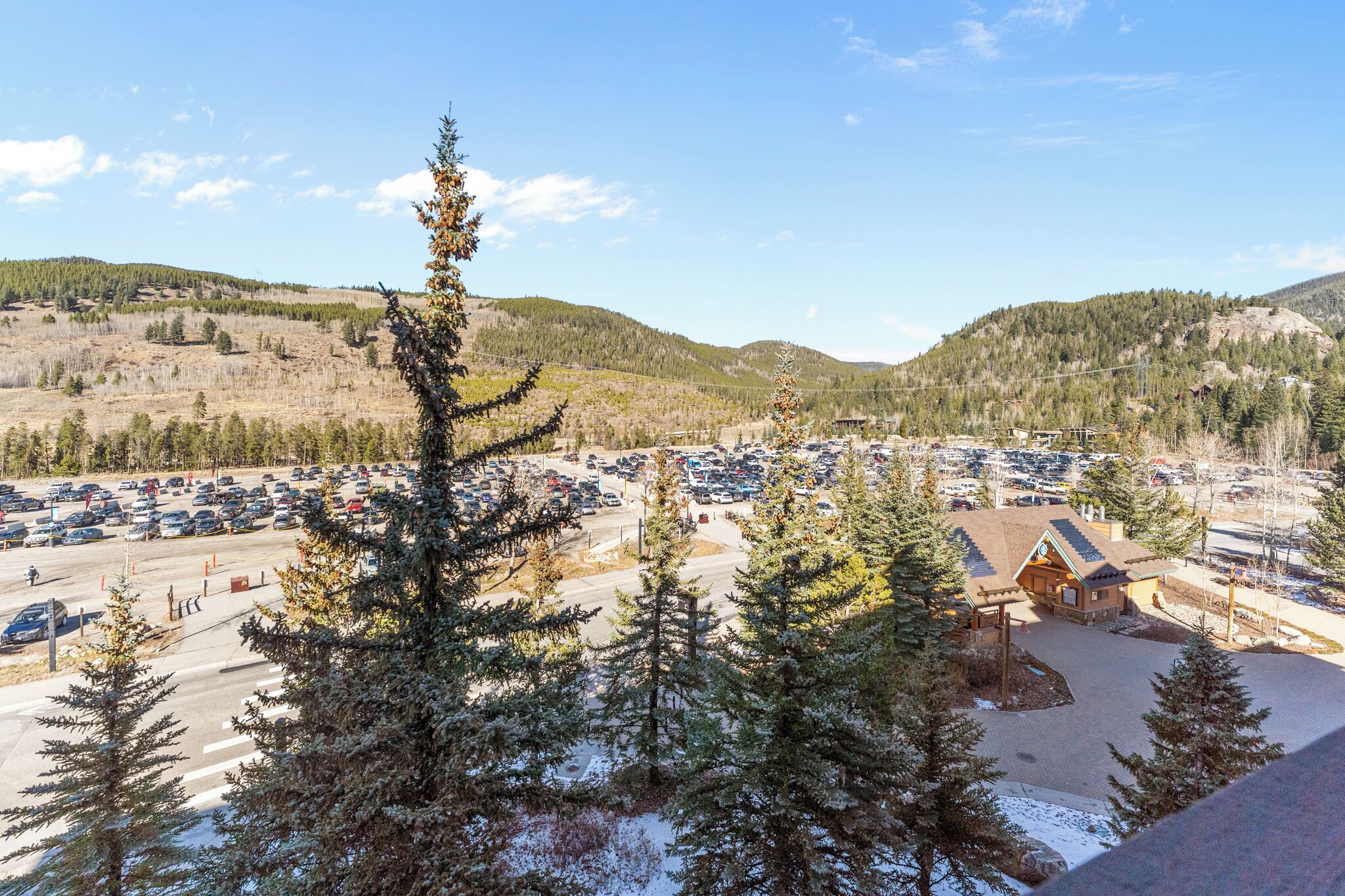 A parking lot with a lodge in the background.
