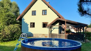A house with a swimming pool, stone foundation, and a wooden deck. - Holiday home Lipno, Slupečná (Lipno nad Vltavou)