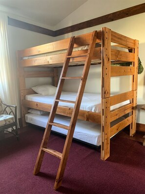 A bunk bed with a wooden ladder, a chair, and a red carpeted floor. - California Craftsman Beach Bungalow in Oceanside! (Oceanside)