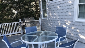 An outdoor patio with a round glass table and four blue chairs. - Close to beautiful beach (Avalon)
