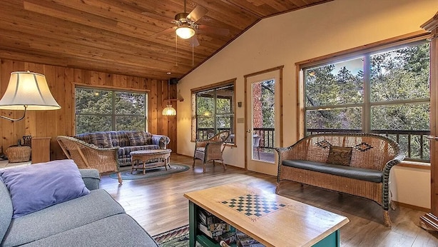 A cozy living room with a sofa, chairs, a coffee table, and a chessboard. - Treetop Getaway in the Ponderosa Pines (Idyllwild-Pine Cove)