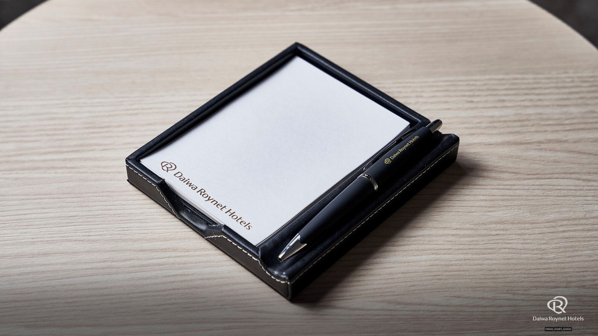 A tablet with a black case, a pen, and a logo on the side.